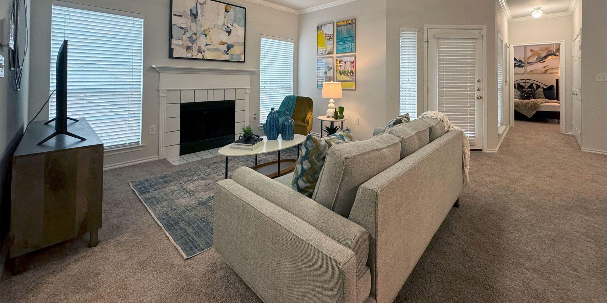 Luxury apartment living room with large windows, wood style floors and contemporary furniture at The Civic at Frisco Square