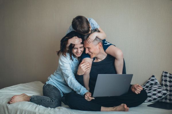 Smiling young couple embracing while looking at smartphone
